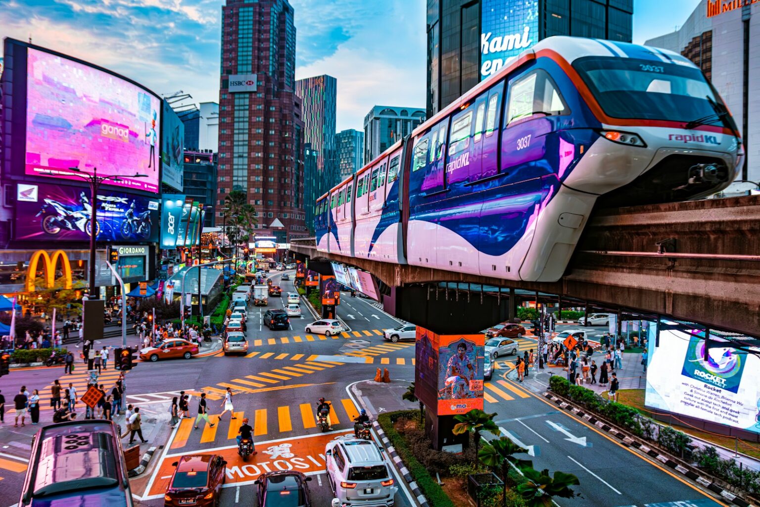 a city street filled with traffic next to tall buildings